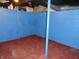 Basement with red flooring and blue painted block walls at 1722 N Parker Ave, Indianapolis, IN 46218