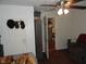 This simple bedroom features hardwood floors, an overhead ceiling fan, and doorway access to the living room at 1722 N Parker Ave, Indianapolis, IN 46218