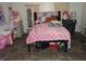 Pink themed bedroom with adorable Hello Kitty accessories and tiled flooring at 1722 N Parker Ave, Indianapolis, IN 46218
