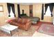 Bedroom featuring wood paneling, a sofa, and a bed with striped bedding at 1722 N Parker Ave, Indianapolis, IN 46218