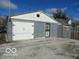 A detached two car garage with white doors and gray exterior at 1722 N Parker Ave, Indianapolis, IN 46218