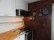 A compact kitchen featuring white cabinets and butcher block countertop at 1722 N Parker Ave, Indianapolis, IN 46218