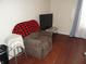 Cozy living room features a recliner chair, TV, and hardwood floors, creating a comfortable and inviting space at 1722 N Parker Ave, Indianapolis, IN 46218
