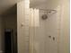 A practical tiled shower with a shower caddy and curtain, providing a clean and functional space at 1722 N Parker Ave, Indianapolis, IN 46218