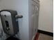 Compact water heater installed in bathroom, situated next to a gray storage cabinet at 1722 N Parker Ave, Indianapolis, IN 46218