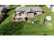 A sprawling backyard with a patio, fire pit, play set, and lush green lawn at 1741 Terrace Ct, Franklin, IN 46131