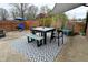 Backyard patio area with outdoor dining furniture, shade cover, and a decorative patterned rug at 1741 Terrace Ct, Franklin, IN 46131