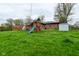 Lush backyard featuring a playset, green lawn, privacy fence, and storage shed at 1741 Terrace Ct, Franklin, IN 46131