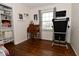 Well-lit bedroom with hardwood floors and a functional desk alongside a modern treadmill at 1741 Terrace Ct, Franklin, IN 46131