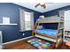 Charming bedroom with a wooden bunk bed, hardwood floors, and a whimsical Mario-themed rug at 1741 Terrace Ct, Franklin, IN 46131