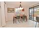 Bright dining area with a modern light fixture, a wooden table, and views to the backyard at 1741 Terrace Ct, Franklin, IN 46131