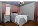 Elegant bedroom showcasing a stylish bed, hardwood floors, and soft, complementary lighting at 1741 Terrace Ct, Franklin, IN 46131