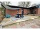 Outdoor patio featuring a brick exterior, dining set, and stylish patterned rug at 1741 Terrace Ct, Franklin, IN 46131