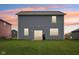 Backyard featuring a well-maintained lawn and the back of the house with sliding glass doors at 1862 Downey Ln, Greenfield, IN 46140