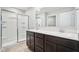 Bright bathroom features a double sink vanity with dark cabinets and a glass-enclosed shower with built-in shelves at 1862 Downey Ln, Greenfield, IN 46140