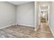 Neutral bedroom featuring wood-look floors, neutral walls, and view into the living room at 1862 Downey Ln, Greenfield, IN 46140
