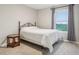 Inviting bedroom with neutral tones, a comfy bed, and a side table near a sunlit window at 1862 Downey Ln, Greenfield, IN 46140