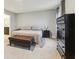 Bright bedroom features carpeted floors, a tufted bench, and a glimpse into the attached bathroom at 1862 Downey Ln, Greenfield, IN 46140