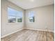 Serene bedroom with wood-look floors, neutral walls, and plenty of natural light from the two windows at 1862 Downey Ln, Greenfield, IN 46140