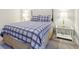 Comfortable bedroom with a classic design featuring plaid bedding, wood-trimmed end table, and soft carpet at 1862 Downey Ln, Greenfield, IN 46140
