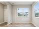 Bright bedroom with neutral walls, light wood-look floors and plenty of natural light from the two windows at 1862 Downey Ln, Greenfield, IN 46140