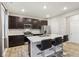 Modern kitchen featuring a large island, stainless steel appliances, and dark wood cabinetry at 1862 Downey Ln, Greenfield, IN 46140