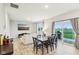 Bright, open-concept living and dining area with sliding glass doors to the outdoor patio and green space at 1862 Downey Ln, Greenfield, IN 46140