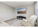 Comfortable living room featuring hardwood floors, a mounted flatscreen tv, and cozy modern chair at 1862 Downey Ln, Greenfield, IN 46140