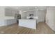 A well-lit, modern kitchen featuring a center island, stainless steel appliances, and gray cabinets at 18745 Moray St, Westfield, IN 46074