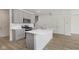 A well-lit, modern kitchen featuring a center island, stainless steel appliances, and gray cabinets at 18745 Moray St, Westfield, IN 46074
