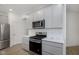 A well-lit, modern kitchen featuring stainless steel appliances and light gray cabinets at 18745 Moray St, Westfield, IN 46074