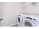Modern laundry room with side-by-side washer and dryer and overhead shelving at 18745 Moray St, Westfield, IN 46074