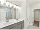Bathroom featuring a double vanity, tiled floor, glass shower door and large mirror at 19113 River Jordan Pass, Westfield, IN 46074