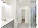 Bathroom featuring a modern vanity, tiled floor, glass shower door, and walk in closet at 19113 River Jordan Pass, Westfield, IN 46074