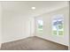 A bright room with neutral carpet, two windows, and white trim throughout at 19113 River Jordan Pass, Westfield, IN 46074