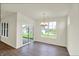 Bright dining room featuring wood flooring, a modern chandelier, and sliding glass door to the backyard at 19113 River Jordan Pass, Westfield, IN 46074