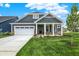Charming home with a two-car garage, stone accents, and manicured front yard at 19113 River Jordan Pass, Westfield, IN 46074