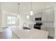 Modern kitchen featuring stainless steel appliances, gray cabinetry, and a central island with pendant lighting at 19113 River Jordan Pass, Westfield, IN 46074
