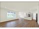 Open-concept living room and kitchen with modern flooring, island, stainless appliances and large windows at 19113 River Jordan Pass, Westfield, IN 46074