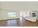 Open-concept living room and kitchen with modern flooring, island, stainless appliances and large windows at 19113 River Jordan Pass, Westfield, IN 46074