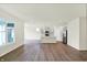 Open-concept living room and kitchen with modern flooring, island, stainless appliances and large windows at 19113 River Jordan Pass, Westfield, IN 46074