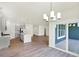 Open-concept living room with wood floors, a kitchen island, recessed lighting, and a sliding glass door at 19113 River Jordan Pass, Westfield, IN 46074