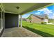 Covered patio overlooks a well-manicured lawn and neighboring homes, creating an inviting outdoor space at 19113 River Jordan Pass, Westfield, IN 46074
