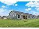 Backyard view of home featuring many windows and a columned patio, with sprawling green space at 19113 River Jordan Pass, Westfield, IN 46074