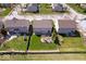 Birds eye view of backyards, featuring a stone patio and verdant lawn, enclosed by fencing at 19546 Forsythe Dr, Noblesville, IN 46060