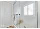 Modern bathroom features a glass shower, white tile walls, and a window for natural light at 19546 Forsythe Dr, Noblesville, IN 46060