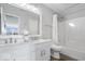 Bright bathroom with double sink vanity, large mirror, and shower with a curtain at 19546 Forsythe Dr, Noblesville, IN 46060