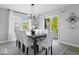 A dining area showcases an elegant lighting fixture and direct access to the backyard through sliding doors at 19546 Forsythe Dr, Noblesville, IN 46060