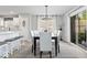 This dining area adjacent to the kitchen includes a contemporary chandelier and sliding glass doors at 19546 Forsythe Dr, Noblesville, IN 46060