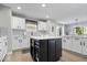 A gourmet kitchen is equipped with stainless steel appliances, a central island, and a tile backsplash at 19546 Forsythe Dr, Noblesville, IN 46060